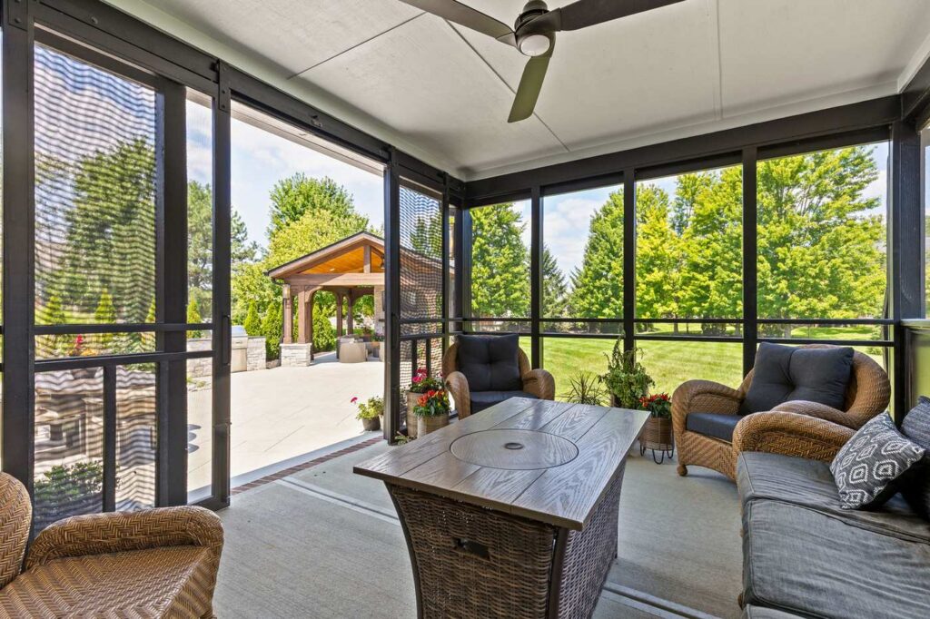 After: Screened porch with sliding screen doors opening toward the patio and backyard pavilion in Carmel.