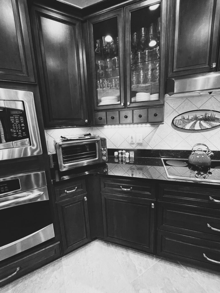 Before the makeover, stained glass-front cabinets, dark countertops and diagonal tile backsplash defined the Westfield kitchen.