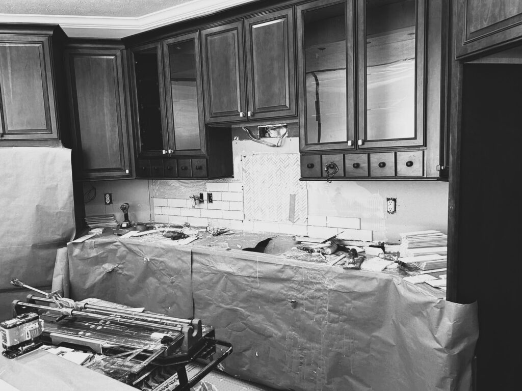 During the Westfield kitchen makeover, white subway tile and the herringbone accent were being installed behind the cooktop.