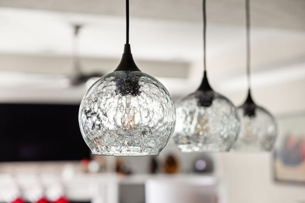 Three textured glass pendant lights hanging above the island in the finished Westfield kitchen.